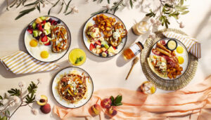 Assortiment de plats de déjeuner du menu d'été de Ben & Florentine garnis de pêches caramélisées et de Miels d'Anicet